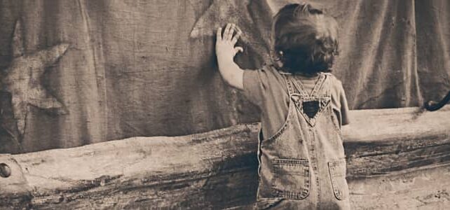 A boy leaning on the Wall